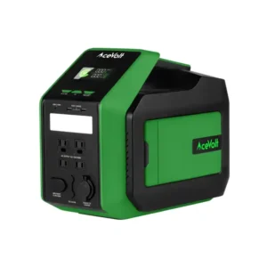 A front and side angled studio product photo of the AceVolt Campower 700 portable power station on a white background, showing its green and black geometric chassis, 45 degree angled display panel, four front AC outlets, USB ports, built in LED flashlight, and AceVolt side branding.