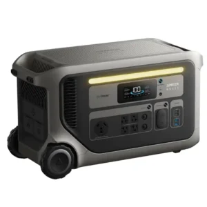 A studio product photo of the Anker SOLIX F3000 portable power station against a white background, showing its dark gray and silver-gray suitcase-style body, active front display, rugged transport wheels, illuminated warm-white light bar, and multiple front and side charging ports.