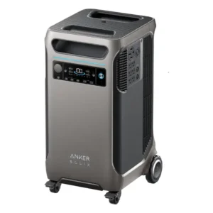 A high-angle studio product photo of the Anker SOLIX F3800 whole-home backup power station on a white background, showing its tall silver-gray and black chassis, dual top carry handles, front LCD display, side-mounted AC outlet panel, and integrated four-wheel mobility system.