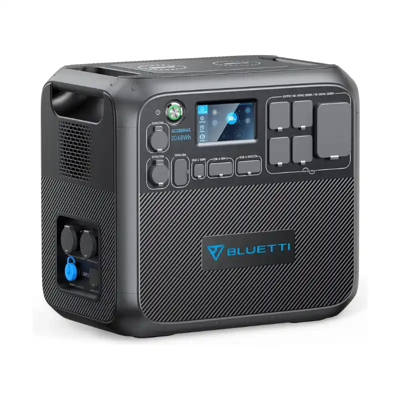 A front-and-side studio photo of the BLUETTI AC200MAX portable power station on a white background, featuring a dark grey casing, touchscreen display showing 50% battery capacity, dual wireless charging pads, side expansion ports, and multiple covered AC, DC, and USB outputs.