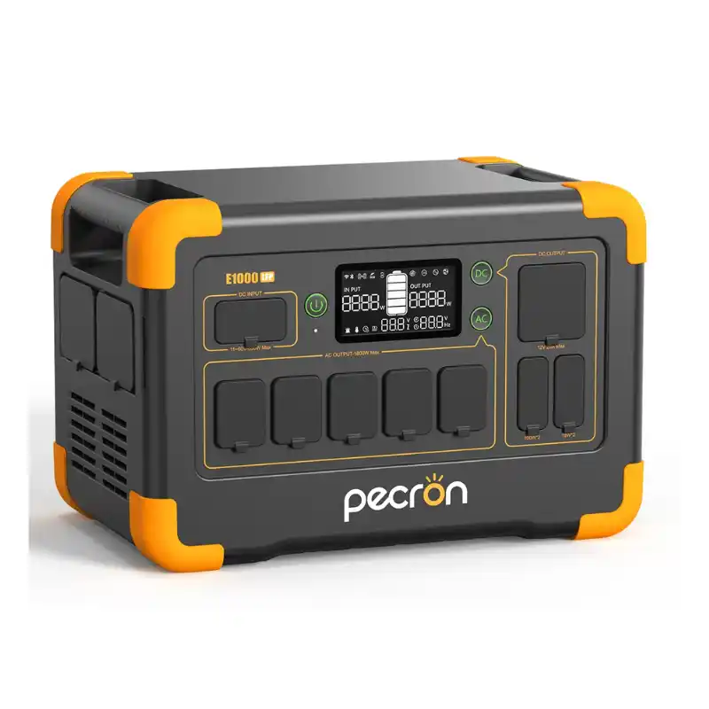 A studio product photo of the Pecron E1000LFP portable power station, showing its rugged gray-and-black chassis with bright orange accents, rubber-covered ports, a central digital display, and integrated carrying handles.