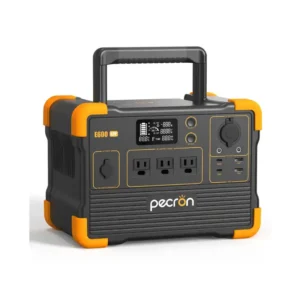 A studio product photo of the compact Pecron E600LFP portable power station on a white background, displaying its dark grey body with signature orange corner bumpers, a high-arching top carrying handle, a central digital screen, and standard AC, DC, and USB outputs.