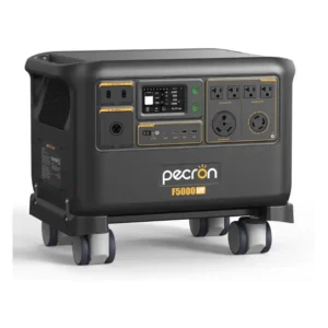 A front-angled studio photo of the Pecron F5000LFP whole-home backup power station on a white background, featuring a dark grey body, bright orange protective corner bumpers, four swiveling caster wheels, a central digital display, and multiple AC and DC outlets.